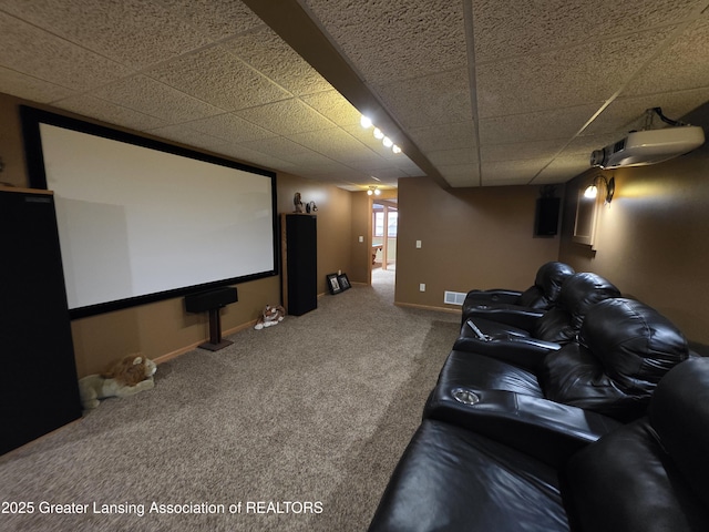 2380 S Waverly Rd, Eaton Rapids, MI 48827 - home theater featuring carpet floors, a paneled ceiling, and baseboards