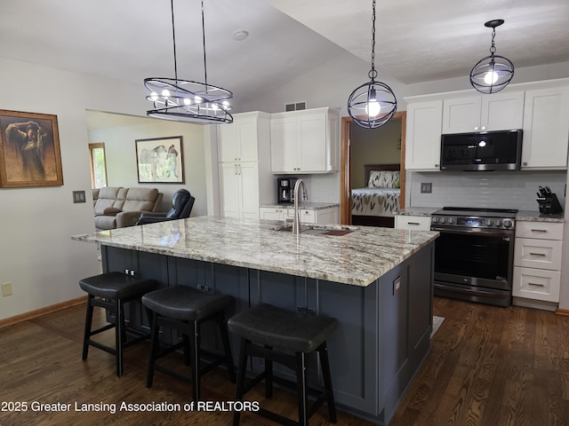 2380 S Waverly Rd, Eaton Rapids, MI 48827 - kitchen featuring appliances with stainless steel finishes, a sink, backsplash, white cabinetry, and dark wood-type flooring