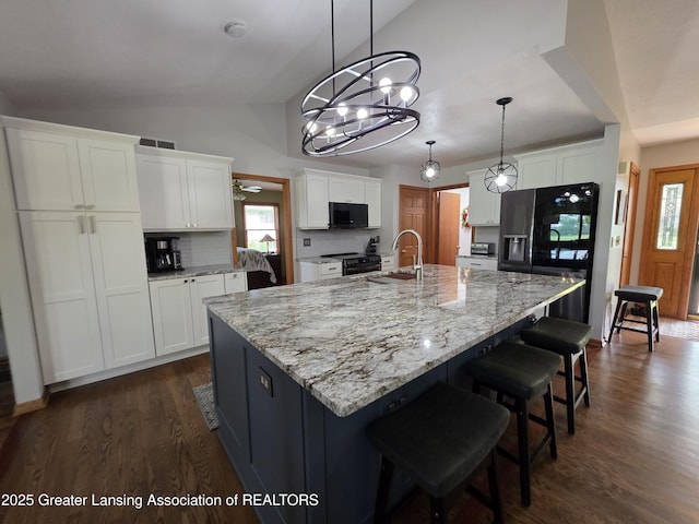 2380 S Waverly Rd, Eaton Rapids, MI 48827 - kitchen featuring black appliances, a sink, lofted ceiling, white cabinets, and dark wood-style floors