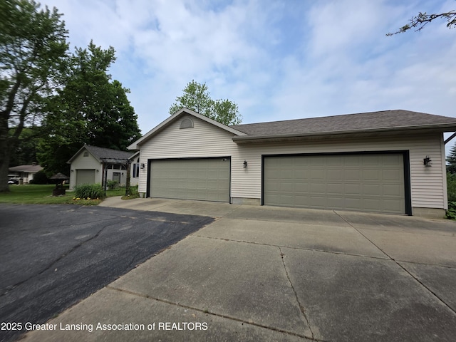 2380 S Waverly Rd, Eaton Rapids, MI 48827 - single story home with concrete driveway and a garage