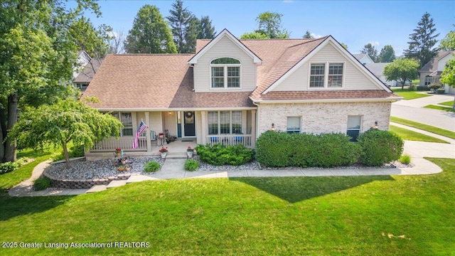2134 Cedar Bend Dr, Holt, MI 48842 - view of front of property featuring a porch, a front lawn, and brick siding