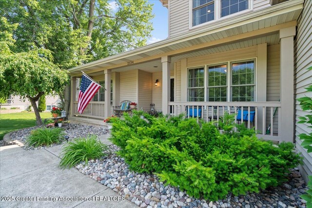 2134 Cedar Bend Dr, Holt, MI 48842 - view of exterior entry featuring covered porch