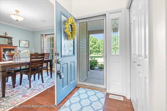 2134 Cedar Bend Dr, Holt, MI 48842 - entrance foyer featuring crown molding and wood finished floors