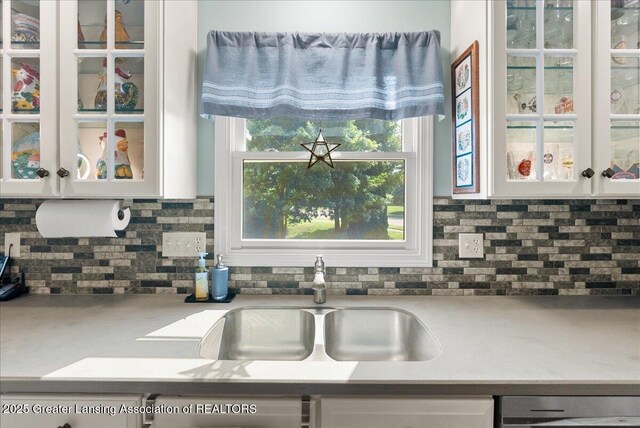 2134 Cedar Bend Dr, Holt, MI 48842 - kitchen with white cabinetry, glass insert cabinets, decorative backsplash, and dishwashing machine