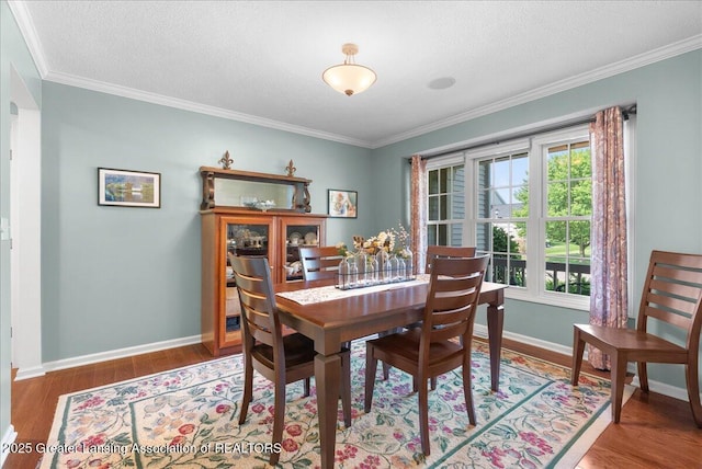 2134 Cedar Bend Dr, Holt, MI 48842 - dining space with wood finished floors, crown molding, and a textured ceiling