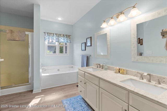 2134 Cedar Bend Dr, Holt, MI 48842 - bathroom with wood finished floors, a shower stall, a bath, and double vanity