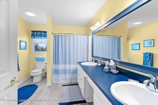 2134 Cedar Bend Dr, Holt, MI 48842 - full bath with wood finished floors, double vanity, and a shower with curtain