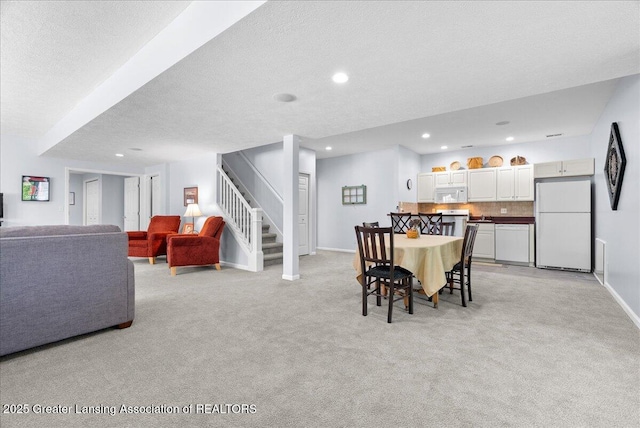 2134 Cedar Bend Dr, Holt, MI 48842 - dining space featuring light carpet, stairs, recessed lighting, and a textured ceiling