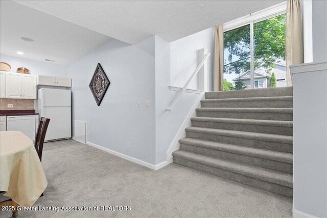 2134 Cedar Bend Dr, Holt, MI 48842 - dining room featuring light carpet, stairs, and recessed lighting