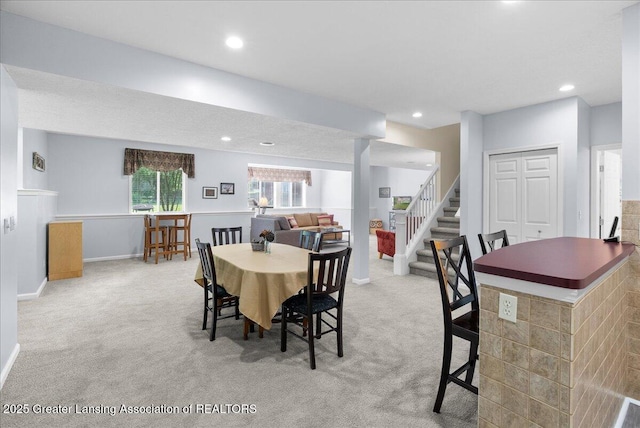 2134 Cedar Bend Dr, Holt, MI 48842 - carpeted dining space with stairway and recessed lighting