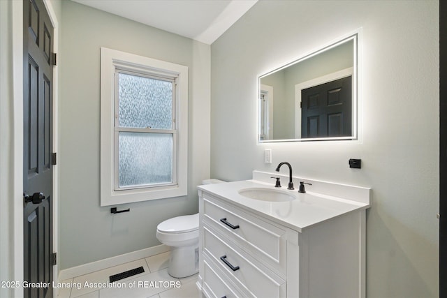2506 W Kalamazoo St, Lansing, MI 48917 - half bathroom with vanity, toilet, baseboards, and tile patterned floors