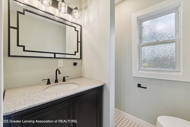2506 W Kalamazoo St, Lansing, MI 48917 - half bath with baseboards, vanity, toilet, and tile patterned floors