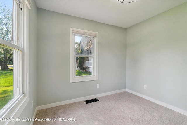 2506 W Kalamazoo St, Lansing, MI 48917 - carpeted empty room with healthy amount of natural light and baseboards