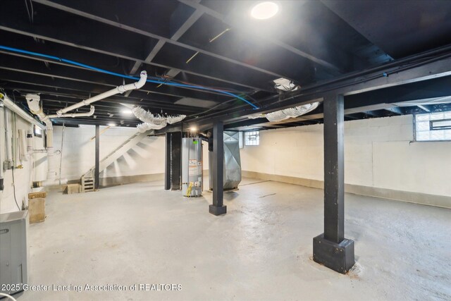 2506 W Kalamazoo St, Lansing, MI 48917 - below grade area featuring water heater, heating unit, stairway, and healthy amount of natural light