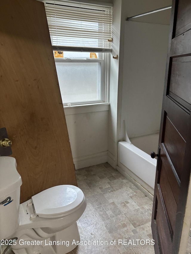 917 E Kalamazoo St, Lansing, MI 48912 - full bath with toilet, stone finish flooring, and shower / washtub combination