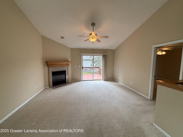 411 White Pine Blvd Unit 34, Lansing, MI 48917 - unfurnished living room with a ceiling fan, carpet flooring, a tile fireplace, and vaulted ceiling