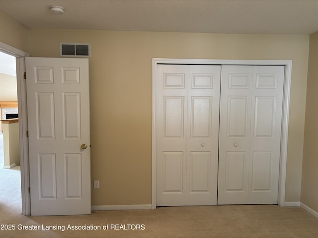 411 White Pine Blvd Unit 34, Lansing, MI 48917 - unfurnished bedroom featuring light carpet and a closet