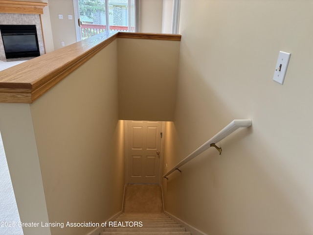 411 White Pine Blvd Unit 34, Lansing, MI 48917 - stairs featuring a fireplace and baseboards