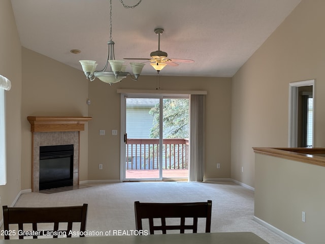 411 White Pine Blvd Unit 34, Lansing, MI 48917 - carpeted living room featuring a ceiling fan, a tile fireplace, and lofted ceiling