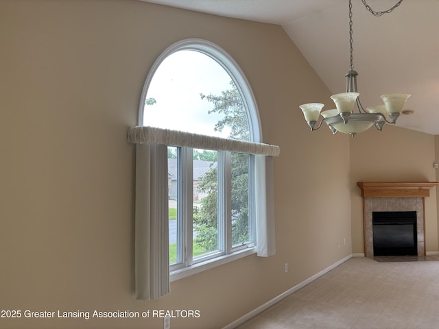 411 White Pine Blvd Unit 34, Lansing, MI 48917 - unfurnished living room featuring a tile fireplace, vaulted ceiling, a chandelier, and carpet floors