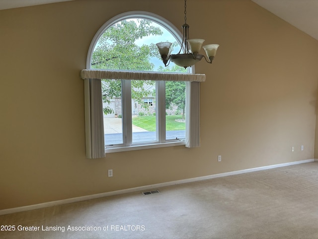 411 White Pine Blvd Unit 34, Lansing, MI 48917 - spare room featuring carpet floors, a chandelier, healthy amount of natural light, and vaulted ceiling