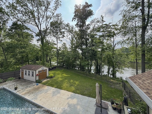 12855 Oneida Woods Trl, Grand Ledge, MI 48837 - view of yard with an outdoor structure, a water view, and a patio area