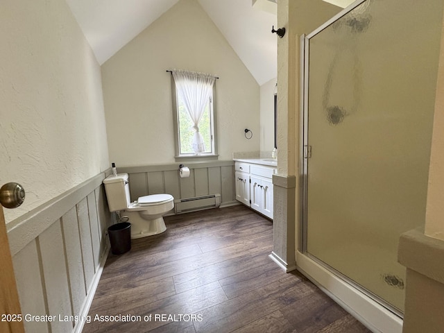 12855 Oneida Woods Trl, Grand Ledge, MI 48837 - bathroom with a baseboard heating unit, a stall shower, wood finished floors, a wainscoted wall, and toilet