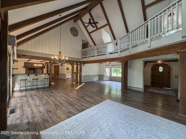 12855 Oneida Woods Trl, Grand Ledge, MI 48837 - unfurnished living room featuring high vaulted ceiling, a chandelier, ceiling fan, a baseboard heating unit, and wood finished floors