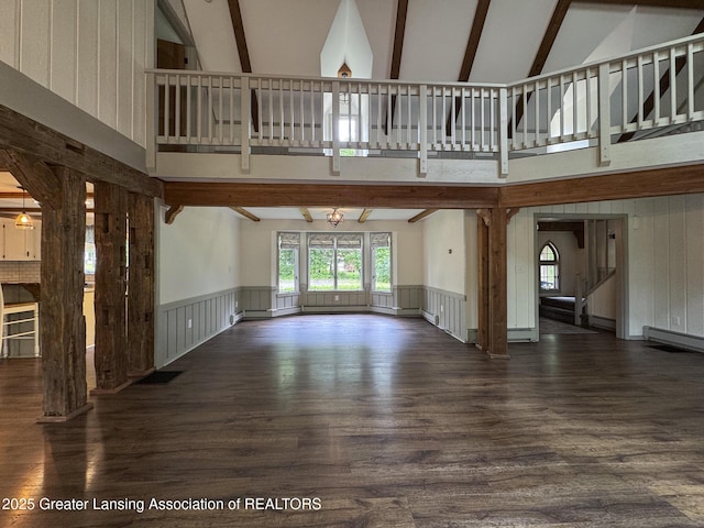 12855 Oneida Woods Trl, Grand Ledge, MI 48837 - unfurnished living room featuring beamed ceiling, high vaulted ceiling, dark wood finished floors, wainscoting, and a baseboard heating unit