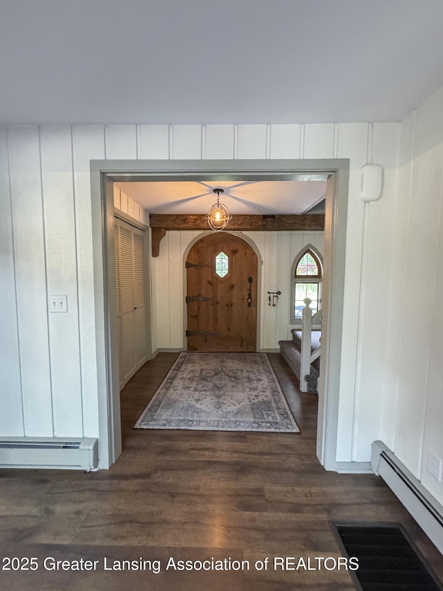 12855 Oneida Woods Trl, Grand Ledge, MI 48837 - foyer entrance featuring baseboard heating, dark wood-style floors, and arched walkways