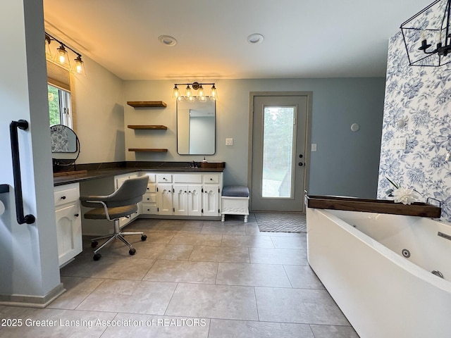 12855 Oneida Woods Trl, Grand Ledge, MI 48837 - bathroom with a whirlpool tub, vanity, and tile patterned floors