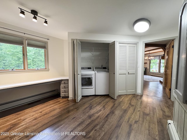 12855 Oneida Woods Trl, Grand Ledge, MI 48837 - laundry area with baseboard heating, washing machine and dryer, a chandelier, and dark wood-style flooring