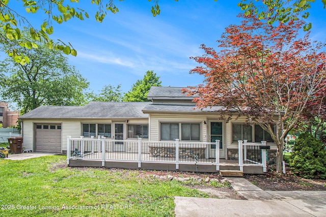 131 W S St, Williamston, MI 48895 - ranch-style house with an attached garage, a front yard, and a shingled roof