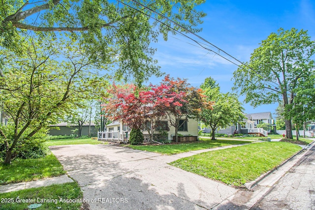 131 W S St, Williamston, MI 48895 - obstructed view of property featuring a porch and a front lawn