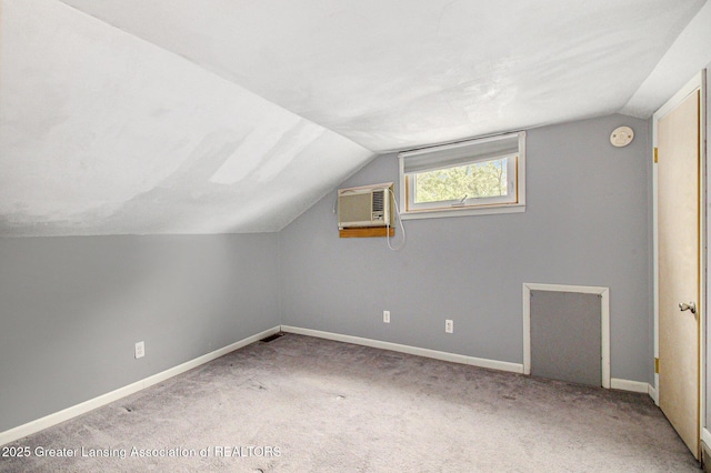 131 W S St, Williamston, MI 48895 - additional living space featuring a wall mounted air conditioner, lofted ceiling, carpet, and baseboards