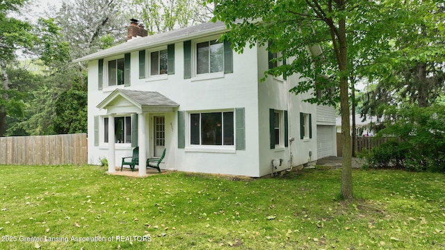 627 State St, Eaton Rapids, MI 48827 - view of front facade with a chimney, stucco siding, and roof with shingles