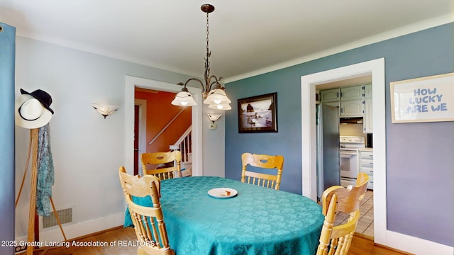 627 State St, Eaton Rapids, MI 48827 - dining area featuring light wood finished floors and baseboards
