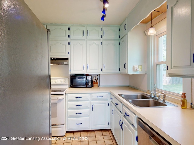 627 State St, Eaton Rapids, MI 48827 - kitchen with white electric range, a sink, freestanding refrigerator, under cabinet range hood, and black microwave