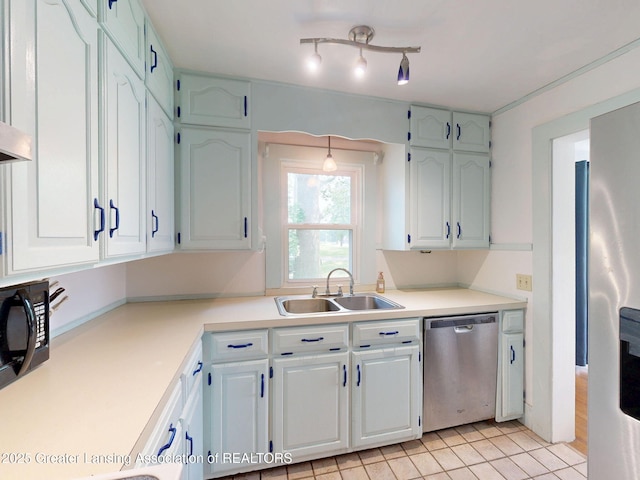 627 State St, Eaton Rapids, MI 48827 - kitchen featuring appliances with stainless steel finishes, a sink, light countertops, and white cabinetry