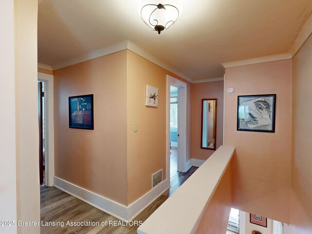 627 State St, Eaton Rapids, MI 48827 - corridor with wood finished floors, baseboards, and ornamental molding