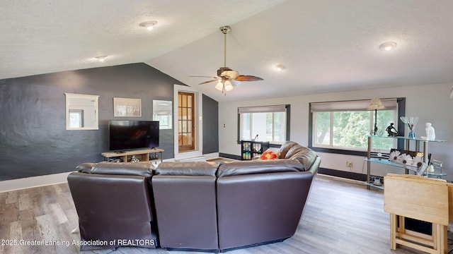 627 State St, Eaton Rapids, MI 48827 - living area featuring baseboards, wood finished floors, ceiling fan, and lofted ceiling