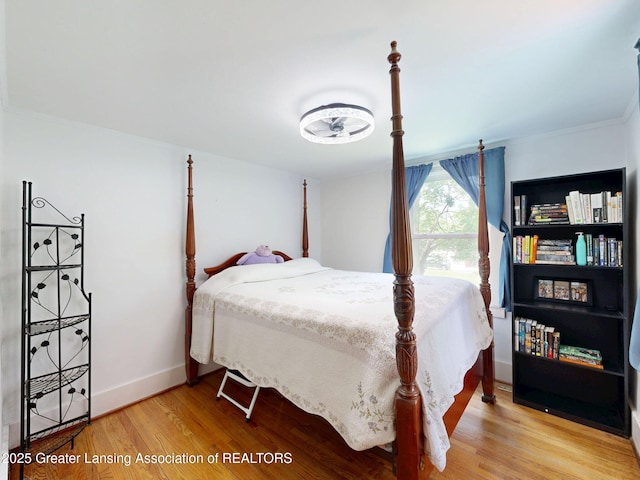 627 State St, Eaton Rapids, MI 48827 - bedroom featuring crown molding, wood finished floors, and baseboards