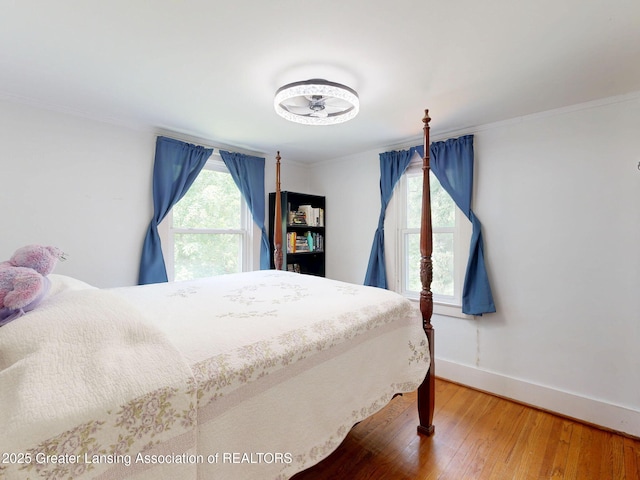 627 State St, Eaton Rapids, MI 48827 - bedroom featuring baseboards, wood finished floors, and ornamental molding