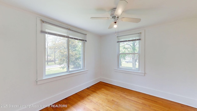627 State St, Eaton Rapids, MI 48827 - spare room featuring plenty of natural light, light wood-type flooring, baseboards, crown molding, and ceiling fan