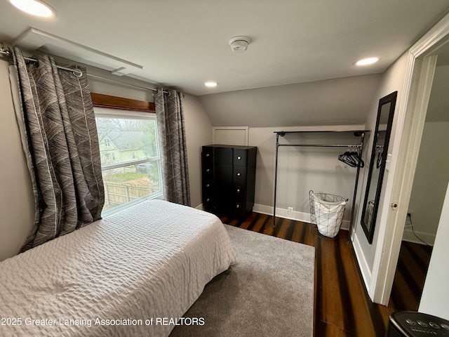 227 S Foster Ave, Lansing, MI 48912 - bedroom with dark wood-style flooring, vaulted ceiling, recessed lighting, and baseboards