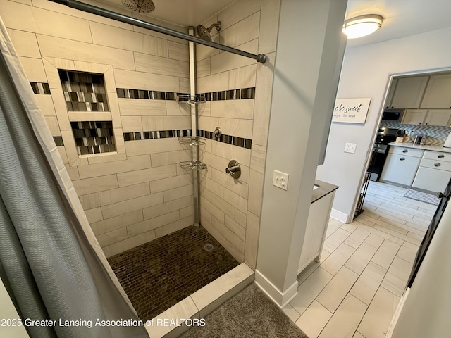 227 S Foster Ave, Lansing, MI 48912 - full bath featuring tiled shower, tile patterned flooring, baseboards, and tasteful backsplash