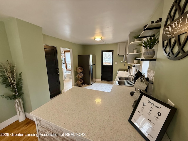 227 S Foster Ave, Lansing, MI 48912 - foyer entrance featuring baseboards and light wood-type flooring