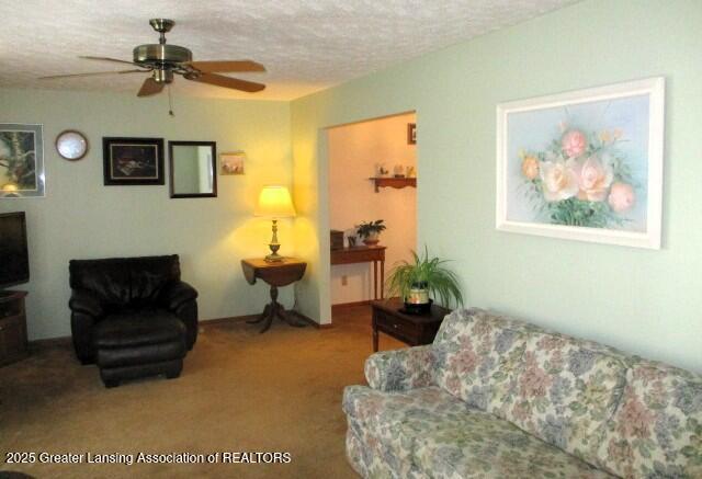 4818 Moultrie Cir, Lansing, MI 48917 - carpeted living room featuring ceiling fan and a textured ceiling