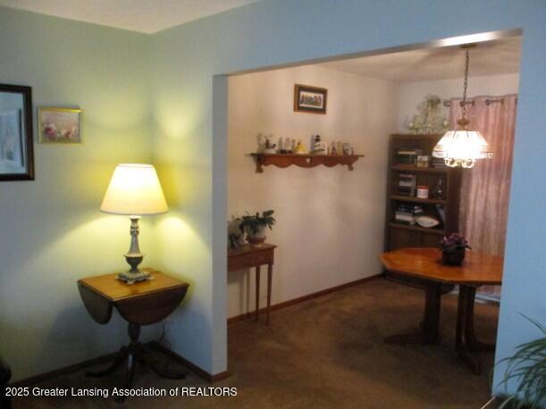 4818 Moultrie Cir, Lansing, MI 48917 - corridor with a chandelier and carpet floors