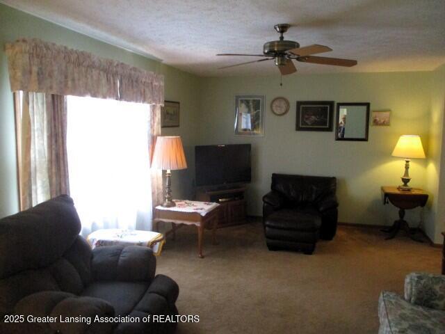 4818 Moultrie Cir, Lansing, MI 48917 - carpeted living area featuring a ceiling fan and a textured ceiling